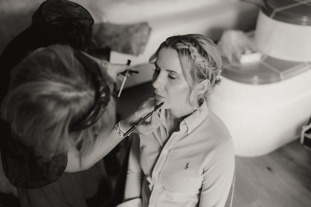 Getting Ready der Braut mit Make-up-Artist vor der Hochzeit in der Deantnerin